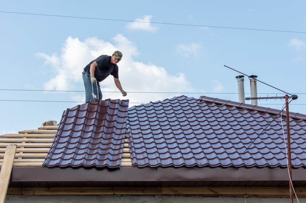 Workers,Install,Metal,Roofing,On,The,Wooden,Roof,Of,A